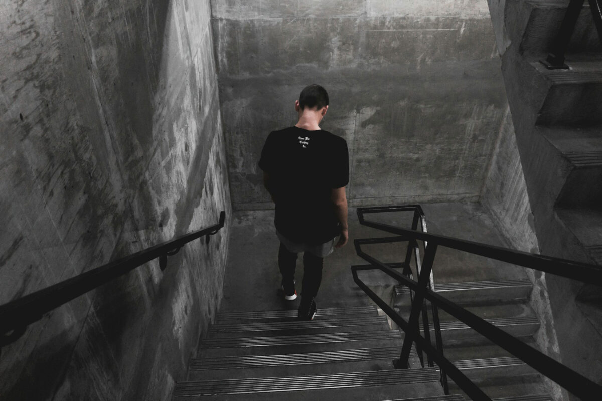 Image of model in black t-shirt with the brand name "Class War Clothing Co." embroidered just below the collar.